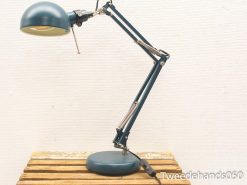 Adjustable teal and cream desk lamp combining modern design with vintage charm for stylish workspaces.