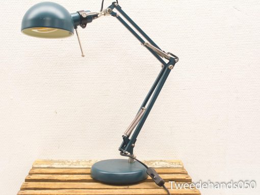 Adjustable teal and cream desk lamp combining modern design with vintage charm for stylish workspaces.