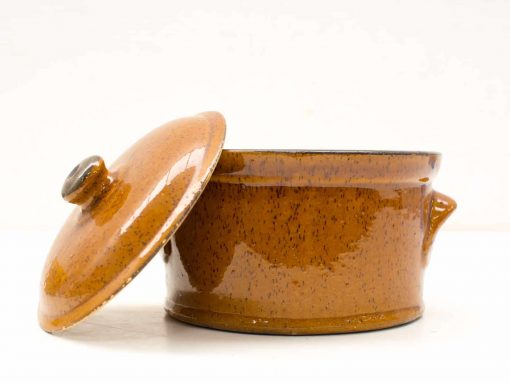 Charming brown ceramic pot with lid and handle, perfect for cooking and serving meals.