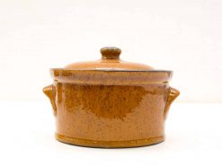 Charming brown ceramic pot with lid, perfect for cooking, serving, and rustic kitchen decor.