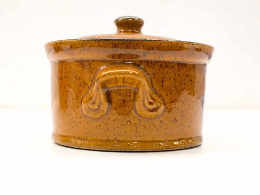Elegant brown ceramic pot with lid, perfect for cooking and serving stylishly.