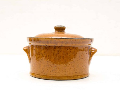 Charming brown ceramic pot with lid, perfect for cooking, serving, and rustic kitchen decor.