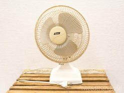 Vintage electric table fan with metal grille and classic design for stylish cooling.
