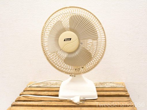 Vintage electric table fan with metal grille and classic design for stylish cooling.