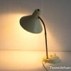 Sleek, minimal desk lamp with flexible neck and warm, diffused light for cozy spaces.