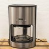 Sleek stainless steel coffee maker with digital display and elegant glass carafe for effortless brewing.