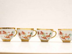 Elegant porcelain cups featuring vibrant dragon motifs and gold accents, perfect for tea or decor.