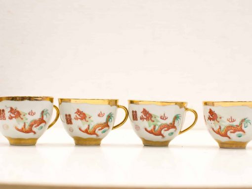 Elegant porcelain cups featuring vibrant dragon motifs and gold accents, perfect for tea or decor.