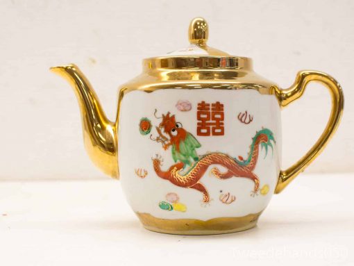 Elegant vintage teapot featuring a dragon design and gold accents, perfect for special occasions.