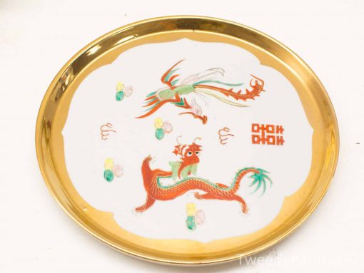 Elegant porcelain plate featuring vibrant dragon motifs and a gold rim, perfect for display.