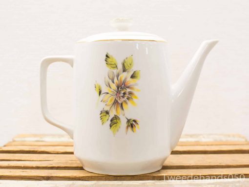 Elegant porcelain teapot with floral design and gold trim for charming tea settings.