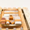 Elegant vintage grooming kit in brown leather with classic tools and luxurious containers.