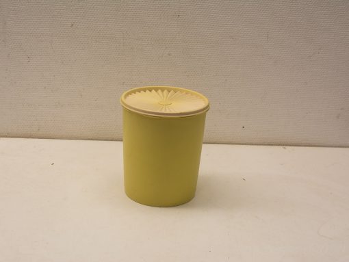 Vintage yellow storage container with decorative lid, perfect for kitchen or craft organization.