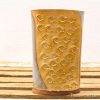 Artisan ceramic vase with fish motif in earthy tones, perfect for decoration or floral displays.