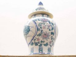 Elegant ceramic urn with lid, adorned with pastel floral designs and intricate craftsmanship.