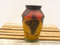 Vibrant vintage bulbous vase with intricate patterns in red, yellow, and black colors.