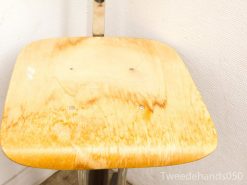 Modern wooden chair with metallic frame, featuring a stylish honey-toned seat.
