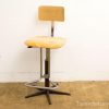 Vintage adjustable stool with wooden seat and chrome frame, perfect for any space.