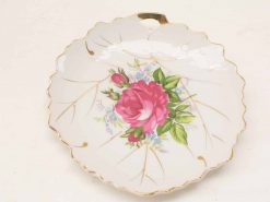 Elegant vintage ceramic dish with rose design and gold accents, ideal for decor or special occasions.