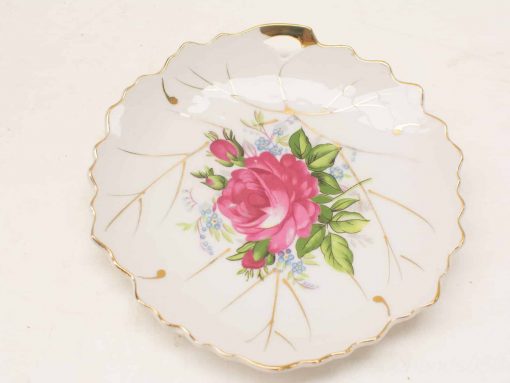 Elegant vintage ceramic dish with rose design and gold accents, ideal for decor or special occasions.