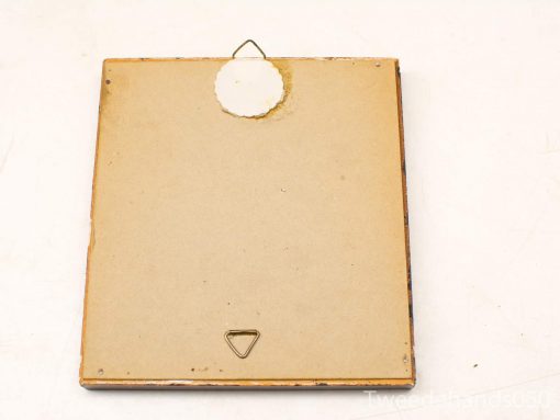 Back view of vintage embroidery frame showing wear, mounting hook, and secure clasp.