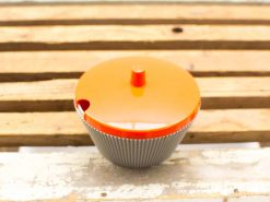 Vibrant orange cupcake container with glossy finish, combining style and functionality for your kitchen.