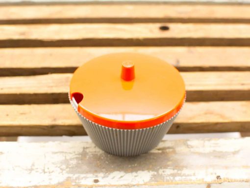 Vibrant orange cupcake container with glossy finish, combining style and functionality for your kitchen.