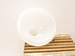Elegant white ceramic bowl with unique hole, perfect for modern decor and functionality.
