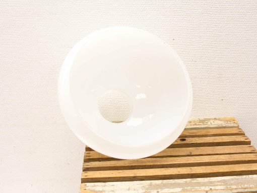 Elegant white ceramic bowl with unique hole, perfect for modern decor and functionality.