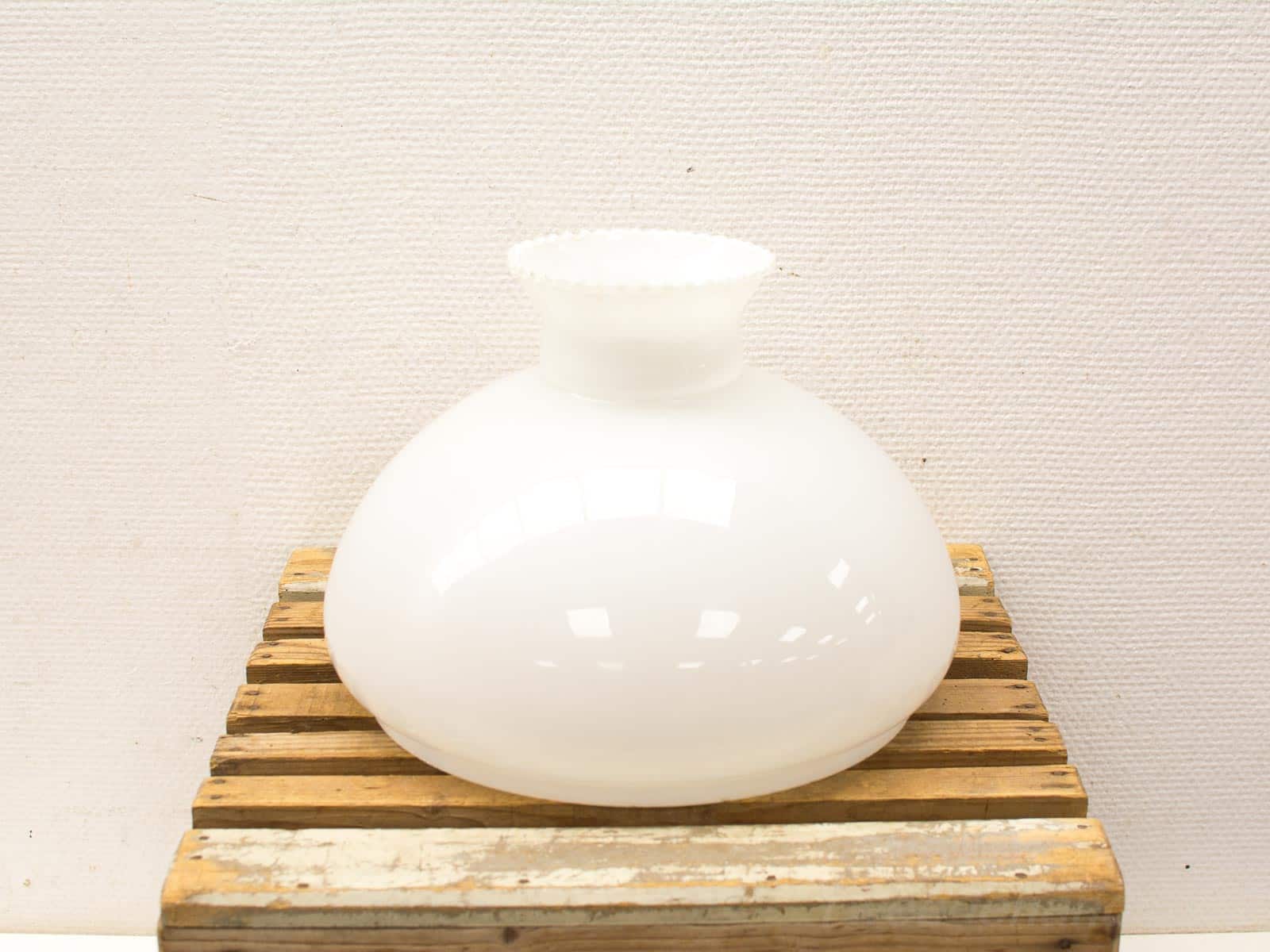 Elegant white glass vase with scalloped rim, perfect for enhancing any decor style.