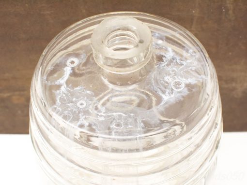 Elegant glass storage jar with lid and pour opening, ideal for kitchen or decor.