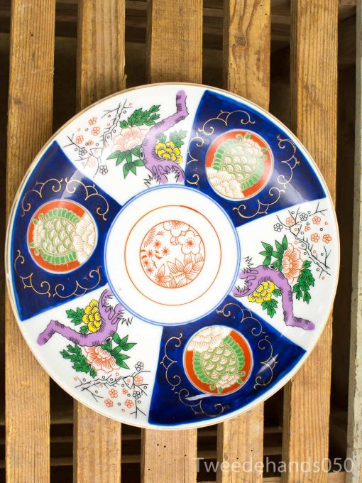 Vibrant decorative ceramic plate featuring intricate floral designs and traditional craftsmanship.