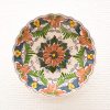 Vibrant floral ceramic bowl, intricately designed with warm colors, perfect for decoration or serving.