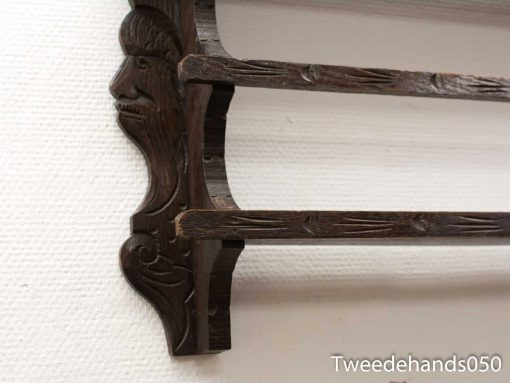 Intricately carved wooden shelf with dark wood finish, showcasing exceptional craftsmanship and artistic design.