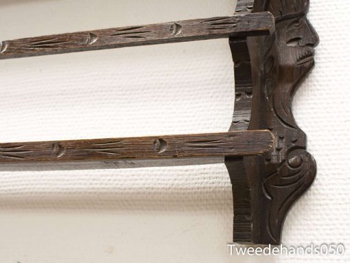 Elegant wooden shelf with intricate carvings, perfect for decoration and stylish storage.