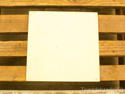 Elegant cream tile on rustic wooden surface, highlighting minimalism and craftsmanship.