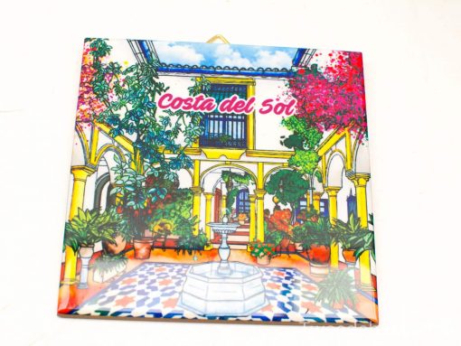 Charming Costa del Sol courtyard with a white fountain, lush greenery, and vibrant tiles.