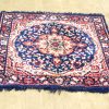 Navy and red handwoven vintage rug with intricate patterns and an ornate medallion design.