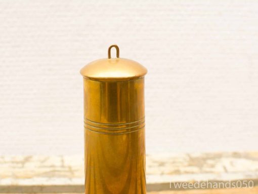 Elegant brass container with lid and subtle grooves, perfect for storage or decor.