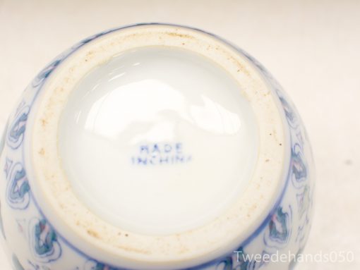Vintage Chinese ceramic vase base with blue and white motifs, showcasing intricate craftsmanship.