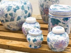 Elegant vintage Chinese porcelain vases and jars with intricate blue floral patterns.