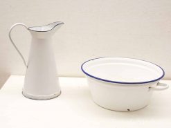 Vintage ceramic pitcher and basin set in white with charming blue trim.