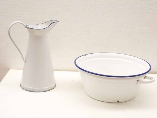 Vintage ceramic pitcher and basin set in white with charming blue trim.