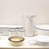 Charming vintage enamel kitchenware collection featuring a basin, pitcher, and unique patterned bowl.