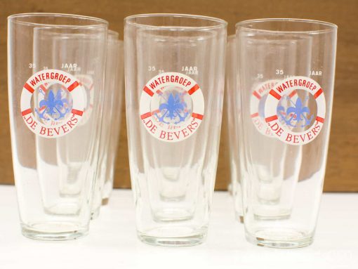 Commemorative drinking glasses for Watergroep De Bevers 35th anniversary, featuring vibrant designs.