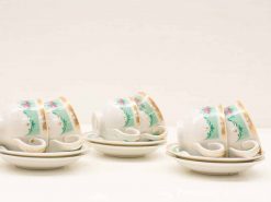 Elegant vintage porcelain tea cups set with floral designs and gold accents for special occasions.