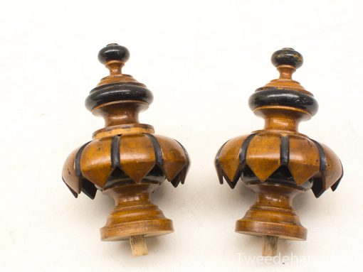 Elegant wooden finials with intricate petal carvings for stylish decor and architectural details.