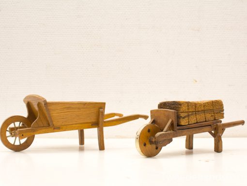 Artisan wooden wheelbarrows showcasing vintage charm and intricate craftsmanship, perfect for decor and gardening.