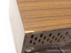 Vintage wooden speaker with character, showcasing warmth and craftsmanship from a bygone era.