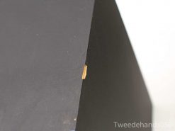 Sleek black triangular decor highlighting modern design and unique imperfections.